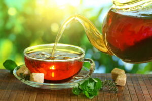 Tea being poured from a teapot into a cup